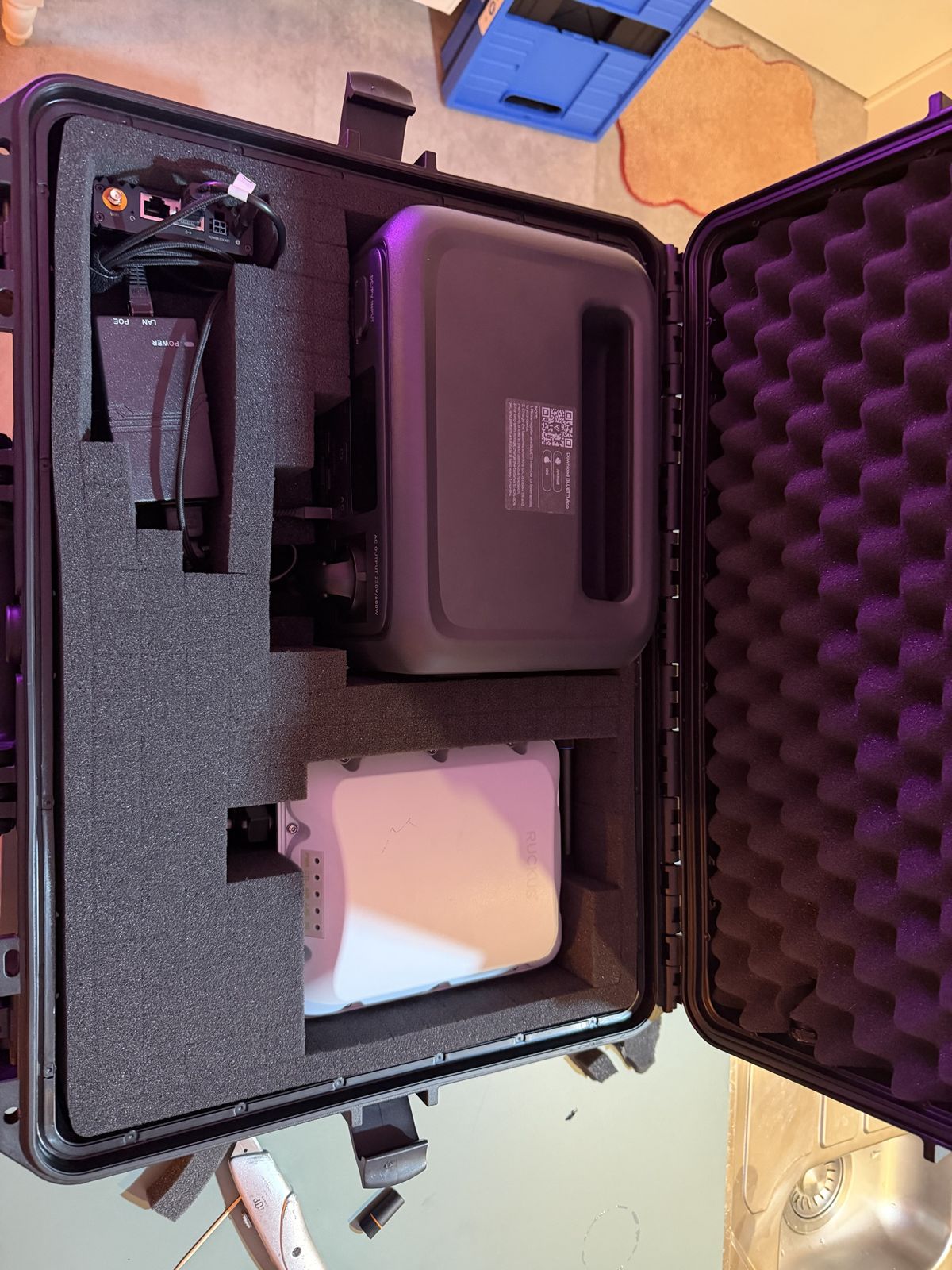 Open case with the PoE injector top left
