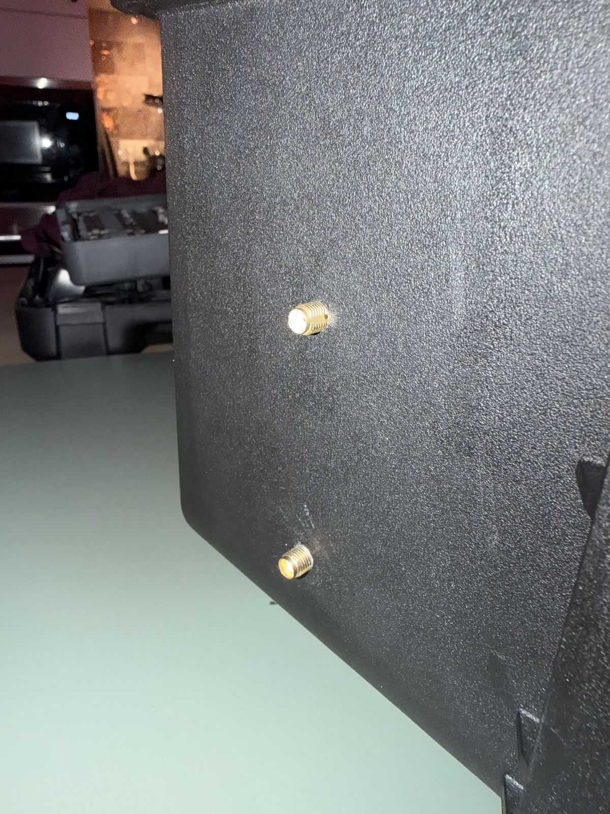 Two gold SMA connectors in the case wall